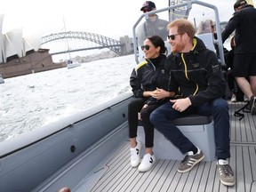 Prince Harry, Duke of Sussex and Meghan, Duchess of Sussex sit looking out at Sydney Harbour during Day 2 of the Invictus Games Sydney 2018 at Sydney Olympic Park in Sydney, Australia, on Saturday, Oct. 21, 2018.