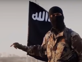 A Canadian ISIS prisoner says that this man, a possible executioner, is also Canadian.