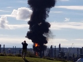 A fire and plume of smoke rises from an Irving Oil refinery following reports of an explosion in Saint John, N.B., on Monday, October 8, 2018. Irving Oil says a "major incident" happened at its oil refinery in Saint John, N.B., this morning. THE CANADIAN PRESS/HO - Nate Guimond