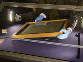 In this Feb. 5, 2015 file photo, The Salisbury Cathedral 1215 copy of the Magna Carta is installed in a glass display cabinet marking the 800th anniversary of the sealing of Magna Carta at Runnymede in 1215, in Salisbury, England.