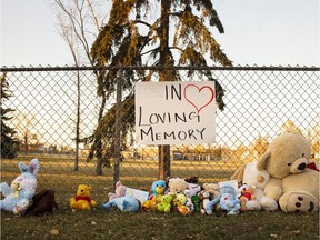 A collection of toys and teddy bears are lined along a fence on Valleyview Road, near the site where a three-year-old boy died after being struck by a car on the morning of Friday, Oct. 19, 2018. Kerianne Sproule/Postmedia Calgary