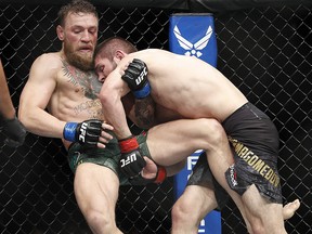 Khabib Nurmagomedov, right, tries to take down Conor McGregor during a lightweight title mixed martial arts bout at UFC 229 in Las Vegas, Saturday, Oct. 6, 2018. (AP Photo/John Locher) ORG XMIT: NVJC140