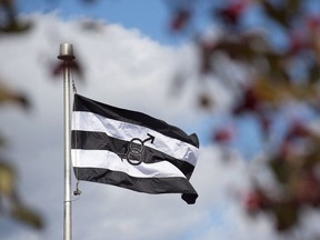 A flag, approved by the village council, flies in Chipman, N.B. on Monday, Oct. 22, 2018. The banner which has been referred to as a "straight flag" has drawn criticism from some residents who say it is harmful to members of the LGBTQ community.