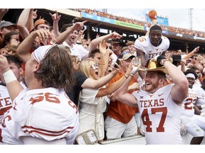 Texas Longhorns tight end Andrew Beck (47) wears the Golden Hat and celebrates with fans after defeating Oklahoma 48-45 in an NCAA college football game at the Cotton Bowl, Saturday, Oct. 6, 2018, in Dallas.