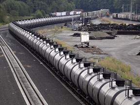 A train loaded with oil sits idle on tracks in Everett, Wash., on Sept. 2, 2014. Alberta Premier Rachel Notley says the province plans to buy up to 7,000 rail cars to move Alberta oil.