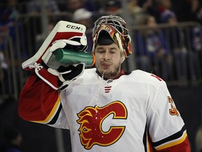 Flames goaltender David Rittich takes a water break during a busy second period against the New York Rangers on Oct. 21, 2018.