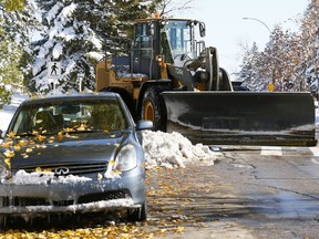 The City of Calgary brought out their big toys but still dealt with drivers not paying attention to the snow ban along Northmount Dr. N.W. as Calgary was in clean up mode after a massive October snow storm crippling the city on Wednesday October 3, 2018. Darren Makowichuk/Postmedia
