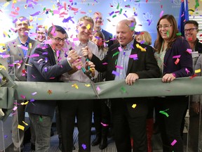 MLA Nathan Cooper, Sundial CEO Torsten Kuenzlen and Olds Mayor Michael Muzychka cut the ribbon at the official opening of Sundial Growers facility in Olds, Alberta Wednesday, October 10, 2018. Dean Pilling/Postmedia