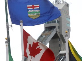 The Alberta and Canadian flags flutter at Canada Olympic Park on Sept. 12, 2018. City council is still waiting to hear from the federal government on what it would contribute to the cost of hosting the 2026 Winter Games.