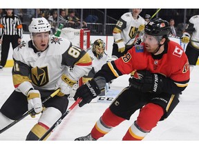Jonathan Marchessault of the Vegas Golden Knights and James Neal of the Calgary Flames go after the puck in the third period of their game at T-Mobile Arena on Friday in Las Vegas. The Golden Knights defeated the Flames 2-0.