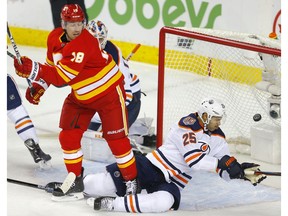 Calgary Flames James Neal, left and  Edmonton Oilers Darnell Nurse collide in NHL hockey action at the Scotiabank Saddledome in Calgary, on Saturday. Photo by Leah Hennel/Postmedia