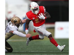Manitoba Bisons linebacker Brody Williams attempts to track down Calgary Dinos running back Jeshrun Antwi during Canada West football playoff action at McMahon Stadium Saturday. The Dinos defeated the Bison 37-13.. Photo by David Moll-Dinos Digital Media/Postmedia.