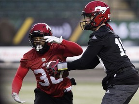 The Calgary Stampeders' quarterback Bo Levi Mitchell (19) and Terry Williams (38) take part in a team practice at Commonwealth Stadium, in Edmonton Friday November 23, 2018. The Stampeders will face the Ottawa Redblacks in the Grey Cup this Sunday. Photo by David Bloom