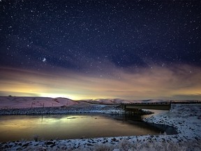 McGregor Lake lit by starlight and the headlights of an oncoming vehicle south of Milo on Sunday, November 25, 2018. Mike Drew/Postmedia