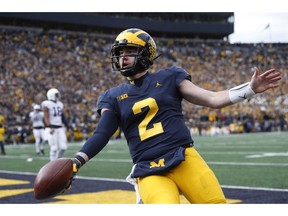 Michigan quarterback Shea Patterson celebrates his one-yard touchdown run in the first half of an NCAA college football game against the Penn State in Ann Arbor, Mich., Saturday, Nov. 3, 2018.