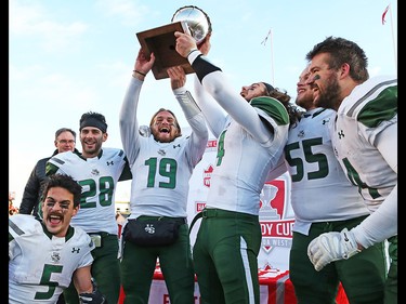 University of Saskatchewan Huskies quarterback (19) Kyle Siemens holds up the Hardy Cup with teammates after defeating the U of C Dinos 43 -18 at McMahon Stadium on Saturday, November 10, 2018.