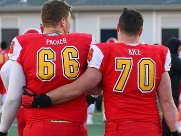 University of Calgary Dinos offensive linemen Tyler Packer and Tristan Rice walk off the field after losing the the Hardy Cup against University of Saskatchewan Huskies at McMahon Stadium on Saturday, November 10, 2018. The Huskies won the game 43-18.