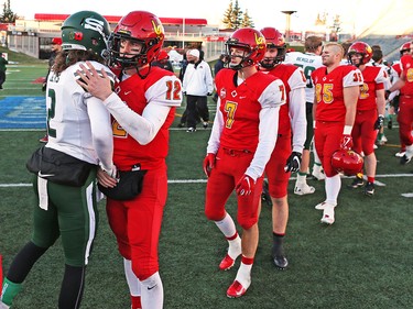 University of Calgary Dinos quarterback Adam Sinagra shakes hands with University of Saskatchewan Huskies players following the Hardy Cup at McMahon Stadium on Saturday, November 10, 2018. The Saskatchewan Huskies won the game 43-18.