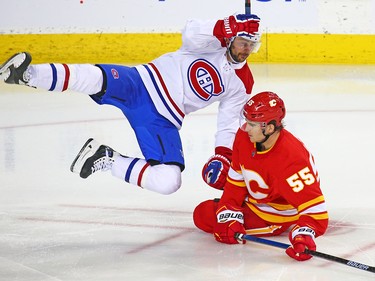 The Montreal Canadiens' Tomas Tatar and  the Calgary Flames' Noah Hanifin collide during NHL hockey action against at the Scotiabank Saddledome in Calgary on Thursday November 15, 2018.