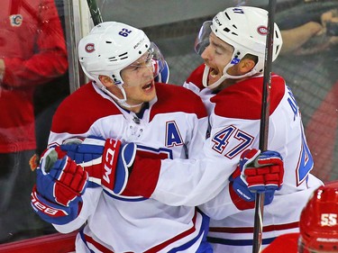 Montreal Canadiens Artturi Lehkonen, left and Kenny Agostino celebrate after the team scored to defeat the Calgary Flames 3-2 during NHL hockey action at the Scotiabank Saddledome in Calgary on Thursday November 15, 2018.