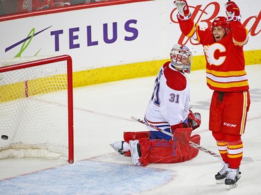 The Calgary Flames' Elias Lindholm celebrates Matthew Tkachuk's goal on Montreal Canadiens goaltender Carey Price  during NHL hockey action against the Calgary Flames at the Scotiabank Saddledome in Calgary on Thursday November 15, 2018.