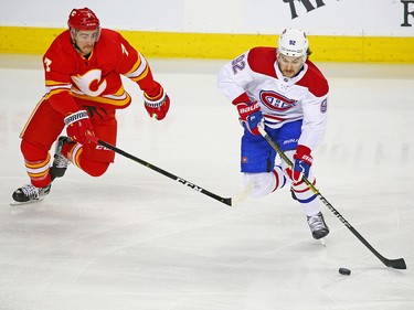 The Calgary Flames' T.J. Brodie chases the Montreal Canadiens' Jonathan Drouin during NHL action at the Scotiabank Saddledome in Calgary on Thursday November 15, 2018.