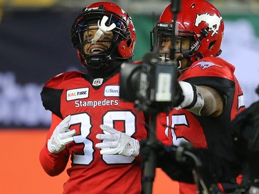 The Calgary Stampeders' Terry Williams, left, celebrates after runming in the ball for a touch down during the first half of the 106th Grey Cup at Commonwealth Stadium in Edmonton on Sunday November 25, 2018.