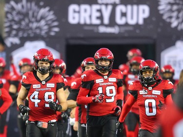 The Calgary Stampeders run on the field at the start of the 106th Grey Cup at Commonwealth Stadium in Edmonton on Sunday November 25, 2018.
