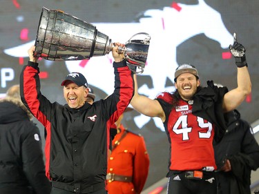 Calgary Stampeders head coach Dave Dickenson raises the Grey Cup after defeating the Ottawa Redblacks at Commonwealth Stadium in Edmonton on Sunday November 25, 2018.