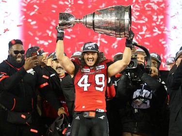 Calgary Stampeders linebacker Alex Singleton holds the Grey Cup after the team defeated the Ottawa Redblacks at Commonwealth Stadium in Edmonton on Sunday November 25, 2018.