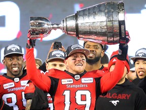 Calgary Stampeders quarterback Bo Levi Mitchell raises the Grey Cup after defeating the Ottawa Redblacks at Commonwealth Stadium in Edmonton on Sunday November 25, 2018.