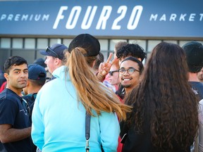 Customers line up to buy cannabis at Four20 Premium Market on Macleod Trail S. in Calgary on Oct. 19, 2018.