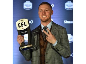 Calgary Stampeders quarterback Bo Levi Mitchell holding up his Most Outstanding Player award at the CFL Awards Gala in Edmonton, November 22, 2018. Ed Kaiser/Postmedia