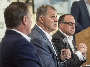 CFL commissioner Randy Ambrosie, centre, speaks to reporters during a press conference with Maritime Football Limited Partnership founding partners Bruce Bowser, left, and Anthony LeBlanc in Halifax on Wednesday, November 7, 2018. (THE CANADIAN PRESS/Darren Calabrese)