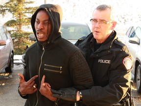 Cordelius Terry Jackson Harrison is taken into Calgary Police custody on Tuesday, November 27, 2018. Harrison is a suspect who ís wanted under a country-wide warrant for a homicide that occurred at Paranoia nightclub. Jim Wells/Postmedia