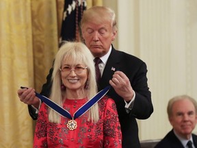 U.S. President Donald Trump presents the Presidential Medal of Freedom to Miriam Adelson during a ceremony in the East Room of the White House, in Washington, Friday, Nov. 16, 2018.