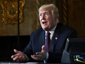 U.S. President Donald Trump speaks with reporters at his Mar-a-Lago estate in Palm Beach, Fla., Thursday, Nov. 22, 2018.