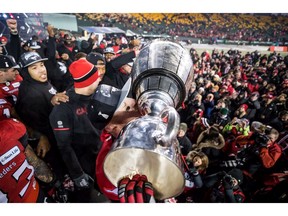Calgary Stampeders quarterback Bo Levi Mitchell kisses the Grey Cup after defeating the Ottawa Redblacks in the 106th Grey Cup CFL championship football game in Edmonton, Alta., on Sunday November 25, 2018.