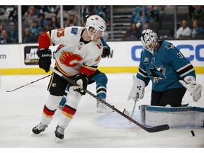 Calgary Flames' Sam Bennett (93) shoots the puck at the net as San Jose Sharks goaltender Martin Jones (31) makes the save in the first period of an NHL hockey game in San Jose, Calif., Sunday, Nov. 11, 2018.
