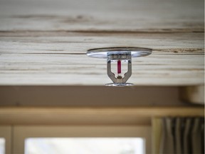 Sprinkler system fixed to a flammable wooden ceiling of a wooden house / cabin