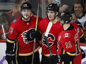 Calgary Flames' Matthew Tkachuk, centre, celebrates his goal with Sam Bennett, left, and Mikael Backlund during the second period against the Vegas Golden Knights in Calgary, Monday, Nov. 19, 2018.