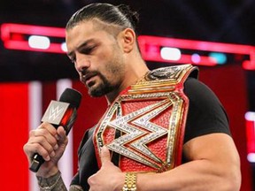 Roman Reigns delivering heartfelt speech announcing his battle with leukemia on Raw. (WWE)