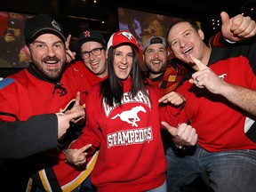 Darcie Cooper and friends cheer on the Calgary Stampeders in the Grey Cup at Schanks North in Calgary on Sunday, Nov. 25, 2018.