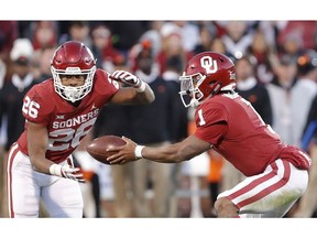 Oklahoma quarterback Kyler Murray (1) hands off the ball to Oklahoma running back Kennedy Brooks (26) during a play against Oklahoma State in the second half of an NCAA college football game in Norman, Okla., Saturday, Nov. 10, 2018. Oklahoma won 48-47.