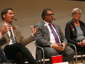 L-R, Councillor for Ward 8 Evan Woolley, Calgary mayor, Naheed Nenshi and No Calgary Olympics, Jeanne Milne during a sold out Olympic Games Plebiscite Town Hall at the new downtown Calgary Public Library in Calgary on Wednesday November 7, 2018. Darren Makowichuk/Postmedia