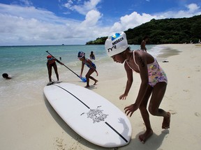 In this June 13, 2009 file photo, children play at a resort beach in Ngerkebesang, Palau. (AP Photo/Itsuo Inouye, File)