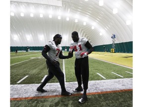 The Calgary Stampeders  Junior Turner, left, and Cordarro Law ,right, work on drills during practice in preparation for the Grey Cup, on Wednesday, Nov. 21, 2018, in Edmonton.