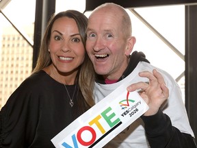 Michael (Eddie the Eagle) Edwards  hams it up with Monica Kretschmer as hundreds came out to support the Yes vote and rally for a 2026 Winter Olympics bid at the Calgary Telus Convention Centre on Monday, Nov. 5, 2018.