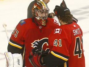Calgary Flames goalie, David Rittich gets a hug from Mike Smith after the Flames beat the Vegas Golden Knights 7-2 at the Scotiabank Saddledome in Calgary on Monday Nov. 19, 2018.