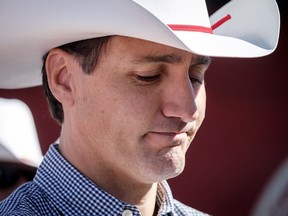 Prime Minister Justin Trudeau listens to speeches as he attends a pancake breakfast in Calgary on Saturday, July 7, 2018. (THE CANADIAN PRESS/Jeff McIntosh)